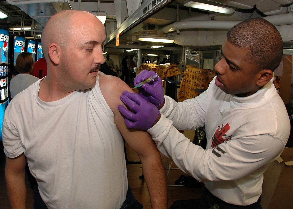 060407-N-4015L-003 Atlantic Ocean (April 7, 2006) - Hospital Corpsman 2nd Class Lawrence Osborne administers a tetanus shot to A Sailor during an immunization stand down aboard the Nimitz-class aircraft carrier USS George Washington (CVN 73). George Washington Carrier Strike Group is currently participating in Partnership of the Americas, a maritime training and readiness deployment of the U.S. Naval Forces with Caribbean and Latin American countries in support of the U.S. Southern Command (SOUTHCOM) objectives for enhanced maritime security. U.S. Navy photo by Photographer's Mate Airman Apprentice Tanner Lange (RELEASED)